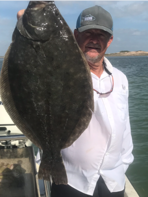 Captian Ryan Falls holding flounder